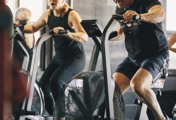 two peoples on gym bike